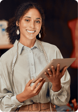 Woman happy with cashflow which is being reviewed on a tablet