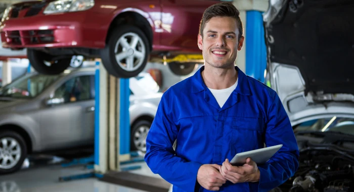 Mechanic holding tablet with workshop management software